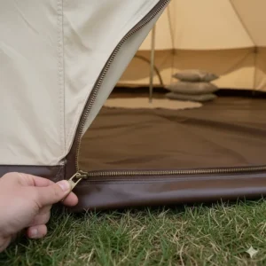 Detail of the heavy-duty zipped-in groundsheet on a 4m bell tent, designed to keep out dampness and insects.