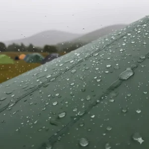 Close-up illustration of rain beads on a silicone-coated nylon ultralight tent flysheet during a British rainstorm.
