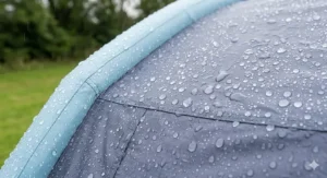 Close-up of rain beads on a high-quality flysheet with a high hydrostatic head rating, essential for British weather.