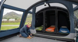 A close-up of a person’s hands typing on a laptop keyboard next to a notepad and a fountain pen, capturing a focused working-from-home atmosphere.