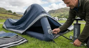 A scenic view of a traditional British high street featuring historic architecture, small independent shops, and pedestrians walking on a paved pavement.