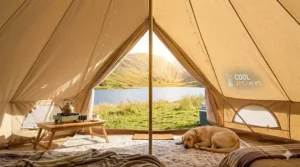 Interior view of a cool polycotton bell tent overlooking a UK lake, demonstrating temperature control in summer.