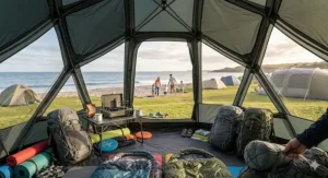 Close-up of a compact geodesic tent in its compression sack being strapped to a hiking rucksack for a trekking trip.