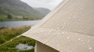 Photorealistic close-up of raindrops beading on a waterproof polycotton tent surface during a British rain shower.