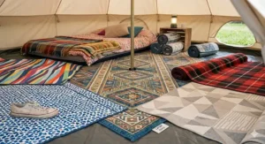 A variety of patterned lightweight tent carpets for festivals, including geometric and ethnic prints for a stylish glamping look.