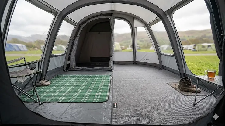 Alt text for image 1: A side-by-side comparison inside a large tunnel tent showing a perfect edge-to-edge fitted carpet versus a smaller universal camping rug. fitted tent carpet vs universal fitted tent carpet vs universal