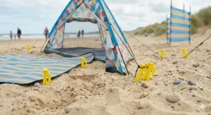 A neat bundle of beach tent pegs packed together in a durable storage bag for your holiday gear.