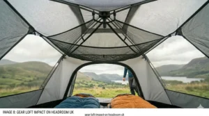 A 4K photorealistic image demonstrating how a mesh gear loft is positioned within a tent, showing that it does not significantly impact headroom, with a hiker visible in the background through the tent door.