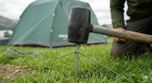 Compact rubber mallet for tent pegs, ideal for lightweight camping rucksacks.