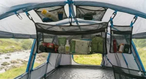 A mesh gear loft for a tent attached to a standard pole structure.