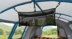 Detailed view of the attachment hooks on a mesh gear loft for a tent.
