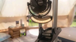 A clip-on tent fan with an integrated, illuminated LED light ring for night-time use.