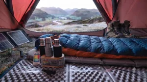 A split-perspective image contrasting the outside and inside of the winter tent. The left side shows the heavily frosted and moisture-laden outer flysheet. The right side shows the clear, dry, and condensation-free fabric of the inner tent, emphasising the effectiveness of the double-wall construction and proper ventilation in maintaining a dry sleeping environment.