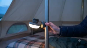 A versatile tent light featuring a magnetic base attached to a metal tent pole for hands-free use.