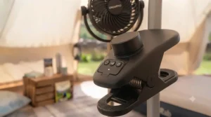 Detailed view of the control panel on a clip-on fan, featuring power and speed settings.