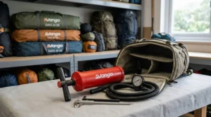 A compact manual tent pump being packed into a rucksack, illustrating its portability for backpacking trips.
