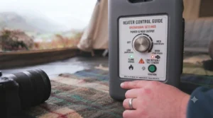 A detailed view of the control panel on the indoor-safe tent heater, showing simple power and heat settings for ease of use in a camping environment.