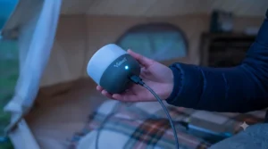 A portable tent light being charged with a USB-C cable, highlighting the convenient recharging feature.