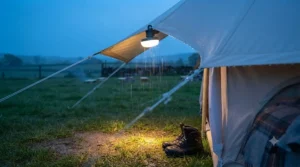 A durable, water-resistant clip on tent light hanging inside a rain-fly, demonstrating weather-proof durability.