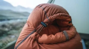Detail shot of an adjustable drawcord hood and insulated draft collar on a mummy-style down sleeping bag.