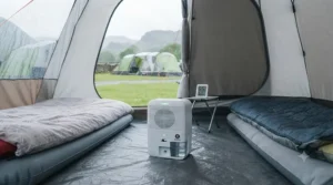A simple infographic showing how a tent dehumidifier pulls moisture out of the air to prevent tent condensation.