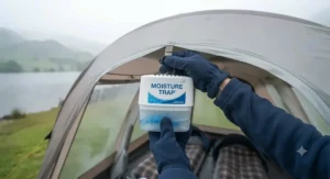 Hanging a hanging moisture absorber for a tent from the interior roof loop to combat dampness.