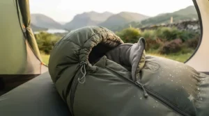 Close-up of a mummy sleeping bag featuring an adjustable hood and thermal draft collar to retain warmth on chilly nights.
