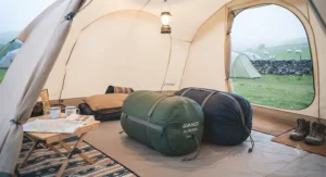 Lightweight zip-together sleeping bags packed into compression sacks for festival camping and hiking.