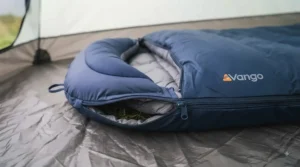 Close-up of a rectangular sleeping bag featuring a full-length zip and integrated headrest for comfort.