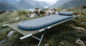 Sleeping mat placed securely on top of a lightweight backpacking cot for extra comfort.[cite: 7]