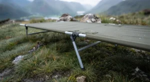 Elevated camping cot providing ground clearance to stay dry on damp terrain.[cite: 6]