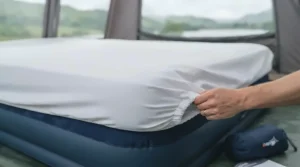 Standard UK double fitted sheet neatly tucked over a double air bed for camping.