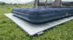Foil insulating groundsheet mat placed underneath a double air bed for camping to retain heat.