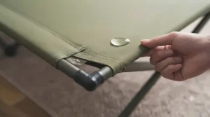 Close-up view of the durable, water-resistant 600D Oxford fabric on a folding camp bed.